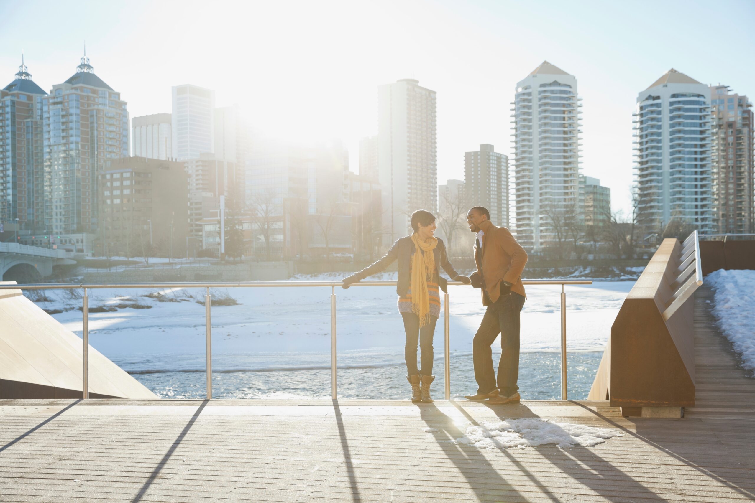 couple-standing-by-river-against-cityscape-2025-10-15-05-16-21-utc